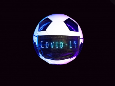 soccer-ball-black-medical-mask-from-virus-light-neon-dark-background_105538-606